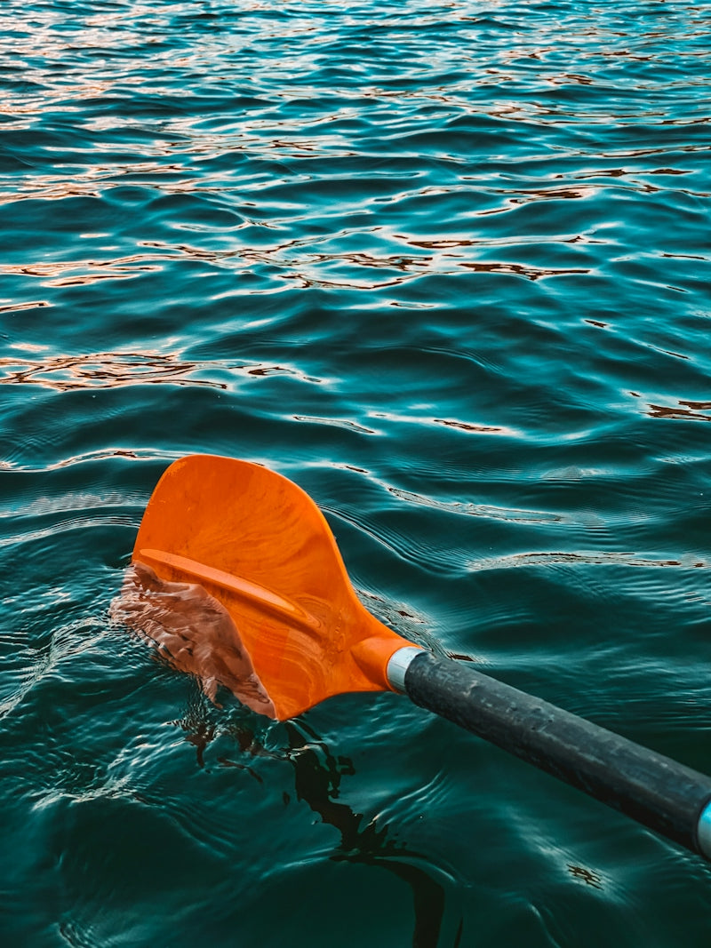 yellow and black kayak on blue sea