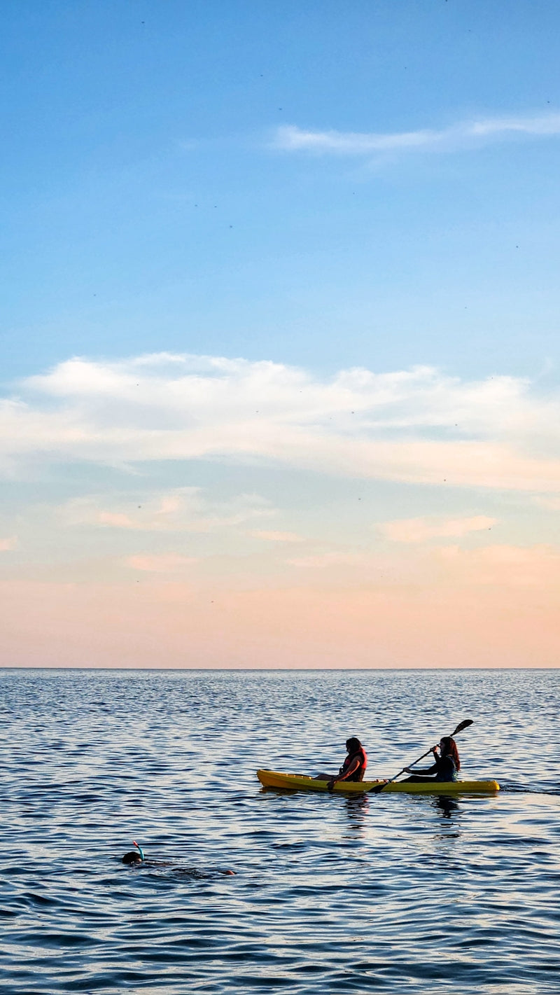 a couple of people on a kayak in the water