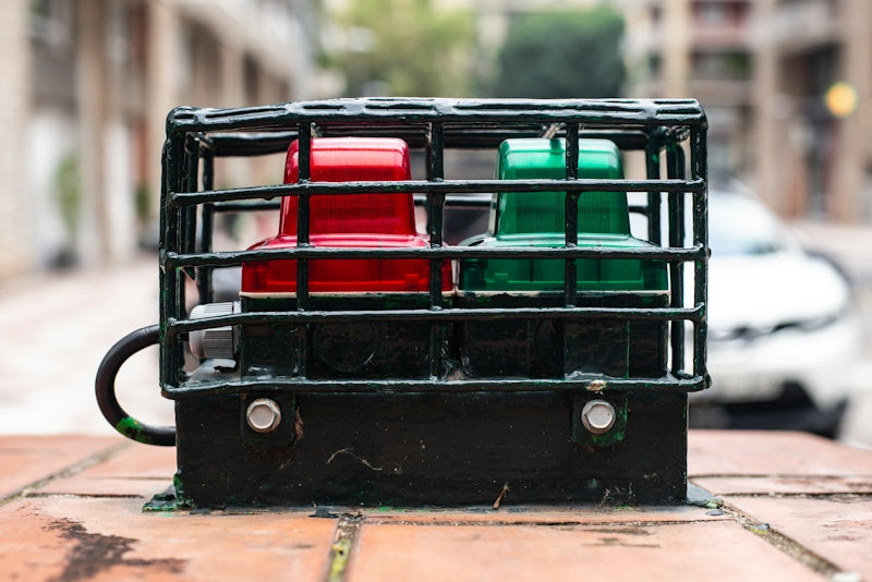 Red and green lights in a protective cage