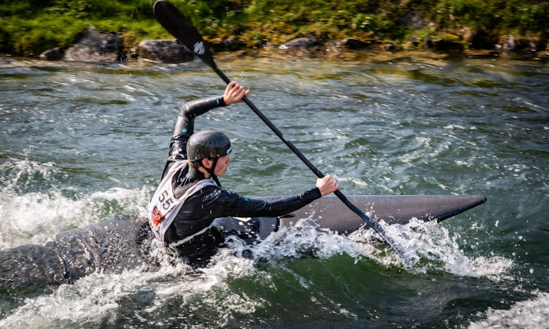 Man kayaking through whitewater rapids
